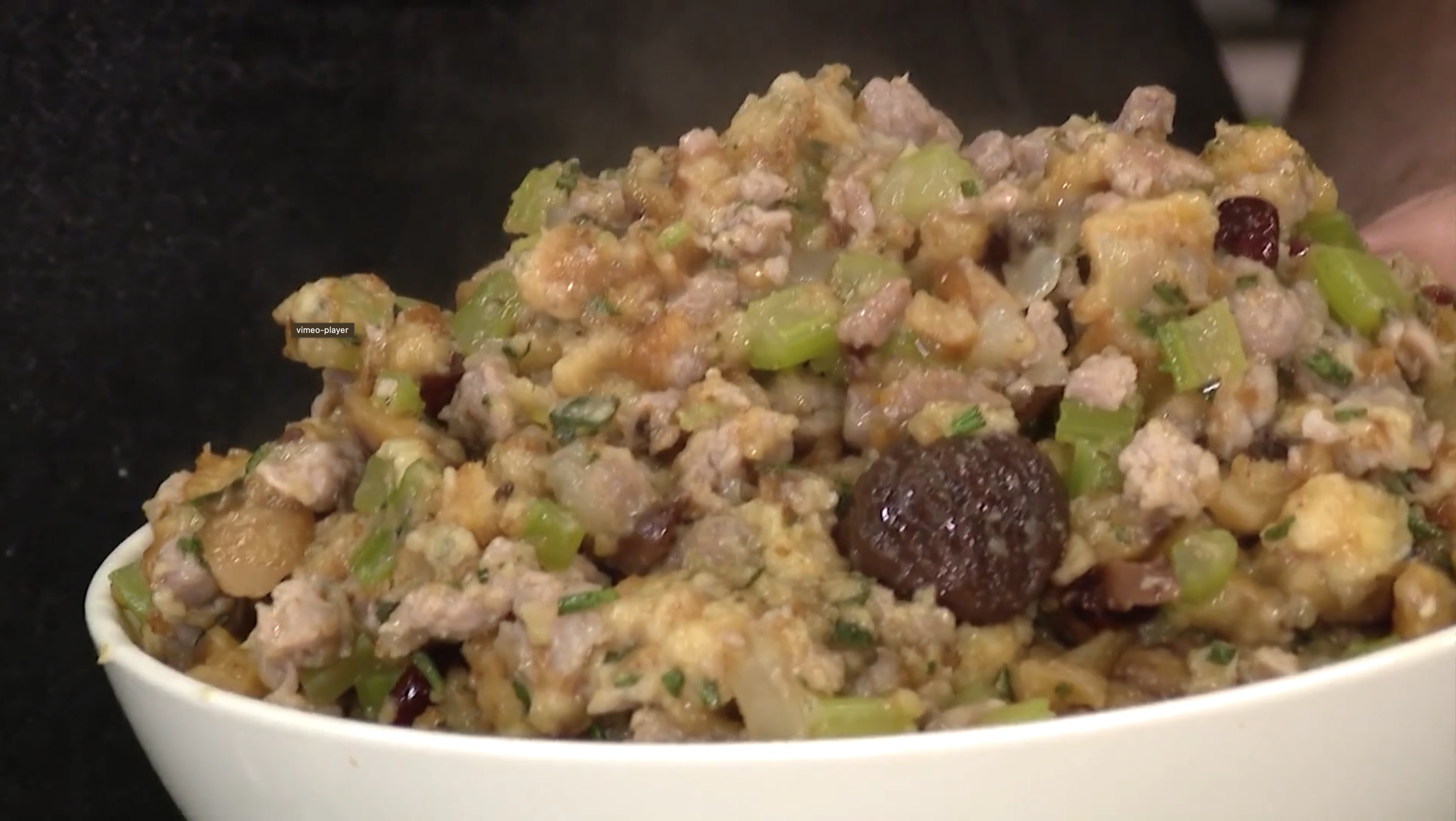 Close up shot of sausage and chestnut stuffing in a white bowl